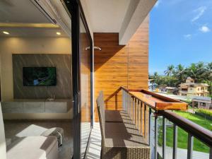 una casa con balcón con vistas al océano en Calm 1BHK Modern Apartment in Candolim with Pool, Balcony & Modern Decor, en Candolim