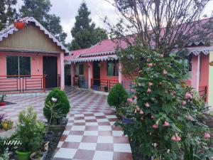 a pink house with a checkered walkway at Open view home stay in Mangpu