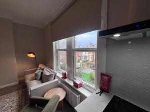 a living room with a couch and a large window at The Bluebird B&B III in Central Station