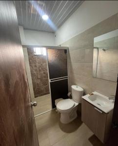 a bathroom with a toilet and a sink at Casa guardían del bosque in San Gil +3 photos