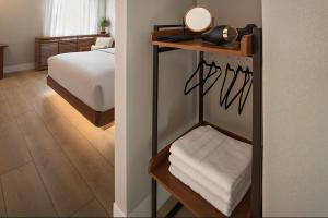 韦恩堡The Amaya - 21 and older only的一个房间，里面有一间卧室，卧室里有一张床，还有一个房间里有一面镜子。