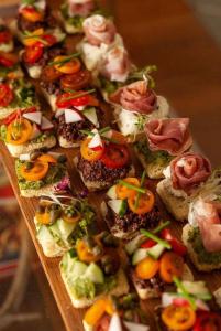 a bunch of appetizers on a wooden board at Hotel Hawai in Villa Carlos Paz