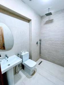 Un baño con un inodoro blanco y un lavabo. en Hotel La Casa Blanca, en Tetuán 68 fotos más