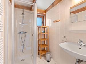 a bathroom with a shower and a sink at Zeepark Haerendycke - Vakantiewoning 40 in De Haan +7 photos
