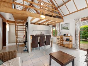 a kitchen and living room with a wooden ceiling at Zeepark Haerendycke - Vakantiewoning 40 in De Haan