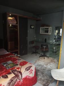 a bedroom with a bed and a desk and a table at Loft central in Pelotas