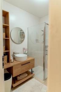 a bathroom with a sink and a shower at Anur Apartment II in Ptuj +7 photos