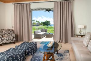 a living room with a couch and a table at Pirates Villa- Beach view with kayaks for Groups in Cruz Bay
