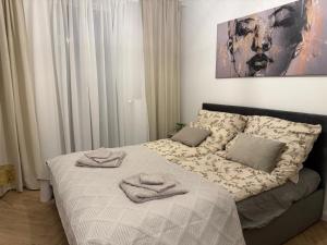 a bedroom with a bed with two towels on it at W275 Apartment in Pruszków
