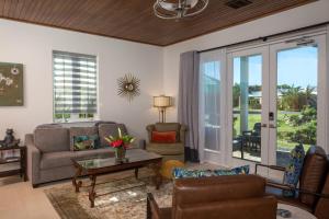 a living room with a couch and a table at Pond Bay Paradise Villa Ocean Views Beach and Kayaks in Monte