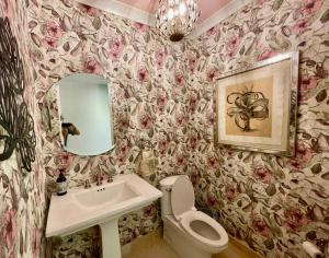 a bathroom with a sink and a toilet and a mirror at Pond Bay Paradise Villa Ocean Views Beach and Kayaks in Monte