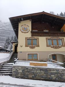 a building with snow on the stairs in front of it at Haus Bernkogel in Sankt Johann im Pongau +26 photos