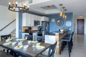 a kitchen and dining room with a wooden table and chairs at Southern Star Villa Kayaks SUPS Steps to Beach in Monte +16 photos