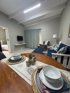 a living room with a table with plates on it at Happy Daze Spacious 45m2 Self Catering Apartment in Swellendam