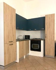 a kitchen with blue cabinets and a sink and a microwave at Morgera N8 in Forio d'Ischia +10 photos