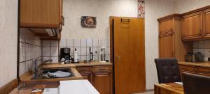 a kitchen with a sink and a counter top at Ramiwi am Teutoburger Wald in Oerlinghausen +8 photos