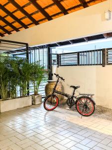 a bike is parked in a room with plants at Pridi cozy home with good location Type A in Bangkok