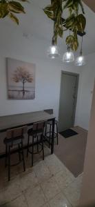 a table and chairs in a room with a tree on the wall at דירת נופש צימר אירוח בצפת צפון קרוב למקווה ורשבי in Safed