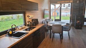 a kitchen with a table and chairs and a stove at Kozacki Domek in Lubowiec