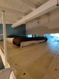 a bed in the middle of a room at NIC Lake House in Sulzano