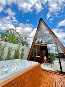 a tub on the deck of a house at Cabanas Farol in Pântano Grande