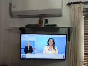 a flat screen tv with a woman on it at Kolymbia home in Kolymbia