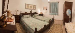 a bedroom with two beds and a table at Kolymbia home in Kolymbia