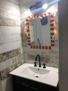 a bathroom with a sink and a mirror at Las Catitas in Villa del Lago