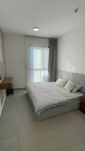 马斯喀特Al Azaiba apartment的一间卧室，配有一张大床和一扇窗户。