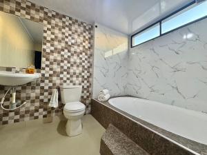 a bathroom with a tub and a toilet and a sink at Las casas de tomate Cartagena in Cartagena de Indias +31 photos