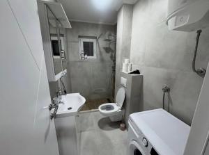 ein kleines Badezimmer mit Toilette und Waschbecken in der Unterkunft Apartman Nina in Foča