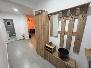 ein Ankleidezimmer mit Holzschränken und einem Spiegel in der Unterkunft Apartman Nina in Foča