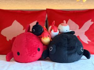 a group of stuffed animals sitting on a bed at Henn na Hotel Tokyo Nishikasai in Tokyo