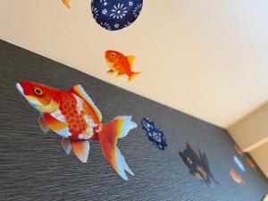 a room with three gold fish on the ceiling at Henn na Hotel Tokyo Nishikasai in Tokyo
