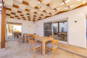 a dining room with wooden tables and chairs at Family Nexus Hotel - Carefree in Hurghada
