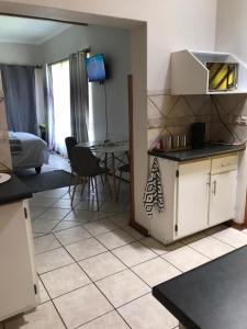 a kitchen with a table and chairs in a room at TANS Garden Cottage in Centurion