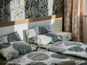 a room with two beds with pillows on it at LilienNest - Stilvolles Apartment mit Panoramablick in Königstein an der Elbe