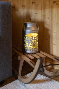 a candle sitting on a wooden stand on a table at Le Petit Mayen in Châtel-Saint-Denis +20 photos