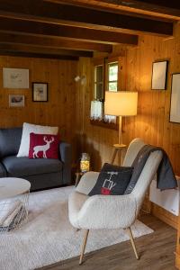 a living room with a couch and a chair at Le Petit Mayen in Châtel-Saint-Denis