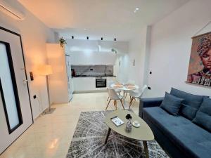 a living room with a blue couch and a table at Hidden Gem 2BR Apartment | Loutraki in Loutraki