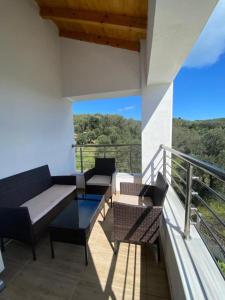 a balcony with two couches and a table and chairs at Theo apartment with Balcony in Marathias +12 photos