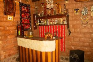 a bar in a room with a brick wall at Casa rústica Pumayalli in Urubamba +18 photos