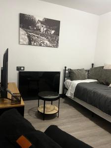 a living room with a bed and a table at Cal Nina in Espluga de Francolí +45 photos
