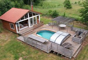 an overhead view of a small house with a swimming pool at Vara Hemma in Smedamåla