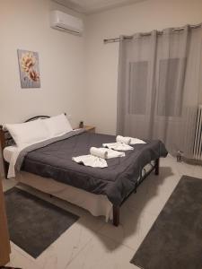 a bedroom with a bed with towels on it at Meteora view Guesthouse in Kalabaka