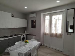 a kitchen with a table with flowers on it at Al civico 14 in Foggia