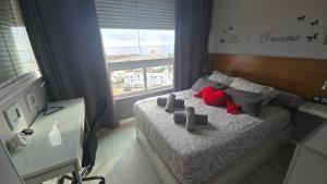 a bedroom with a red stuffed animal on a bed at Estudio III VISTAS MAR, TREN Y MALAGA in Torremolinos