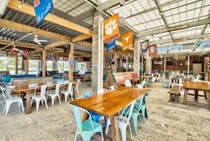 an empty restaurant with wooden tables and chairs at Prominence 30A - Holiday House in Watersound Beach