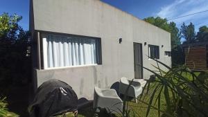 Departamento LUNA NUEVA في سانتا كلارا ديل مار: مبنى أبيض مع نافذة ذات ستائر بيضاء