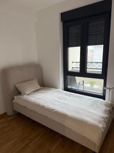 Ένα ή περισσότερα κρεβάτια σε δωμάτιο στο Una Lux Apartment